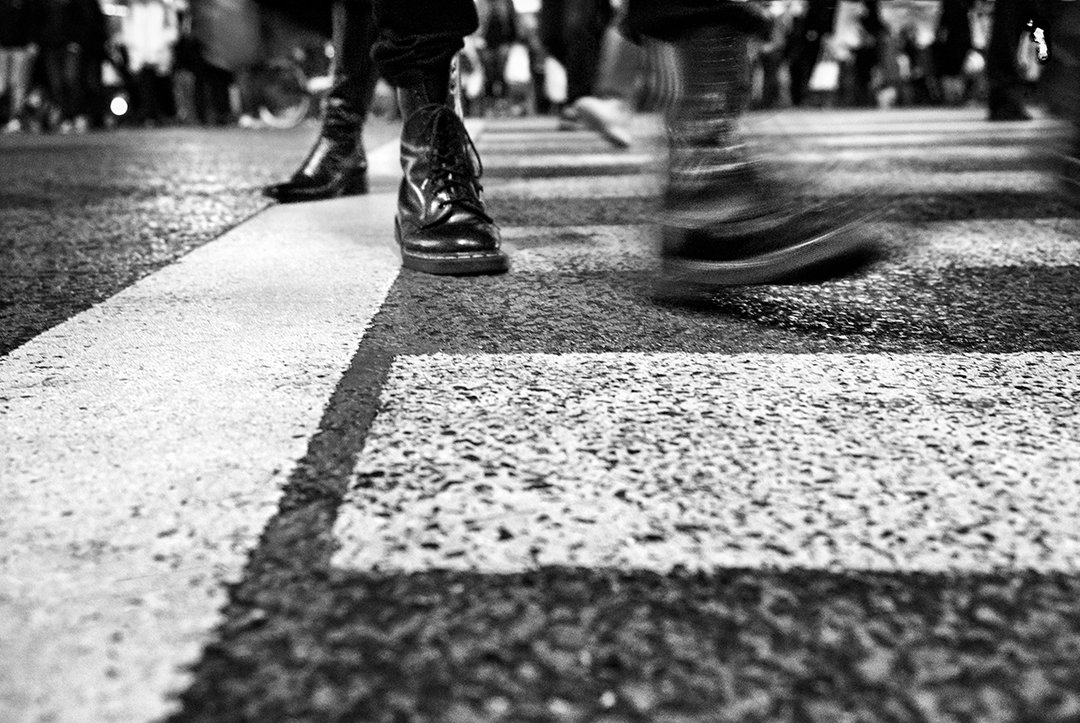 Moving shoes on a pedestrian crossing.